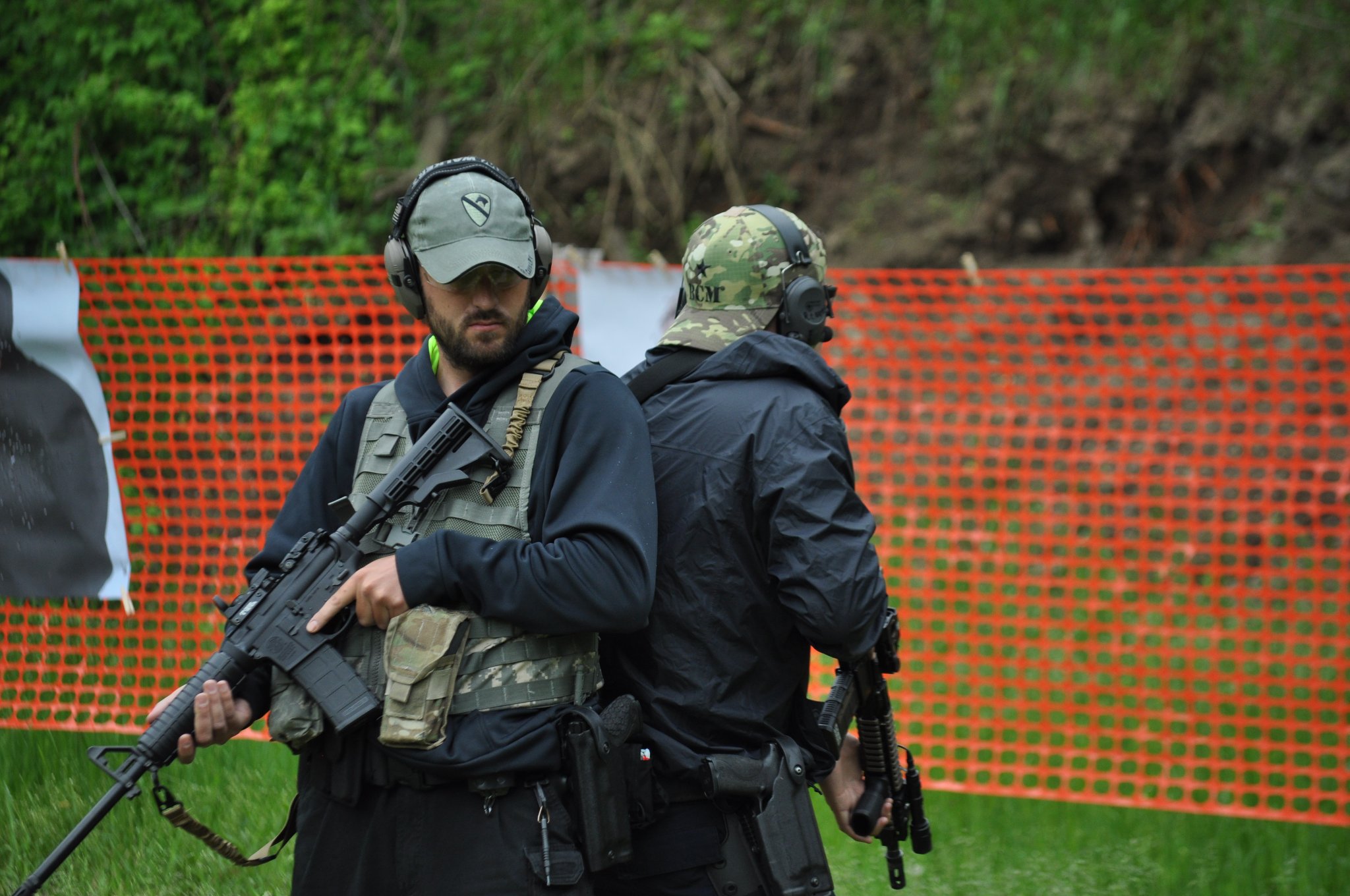 Two instructors with rifles — outdoor range