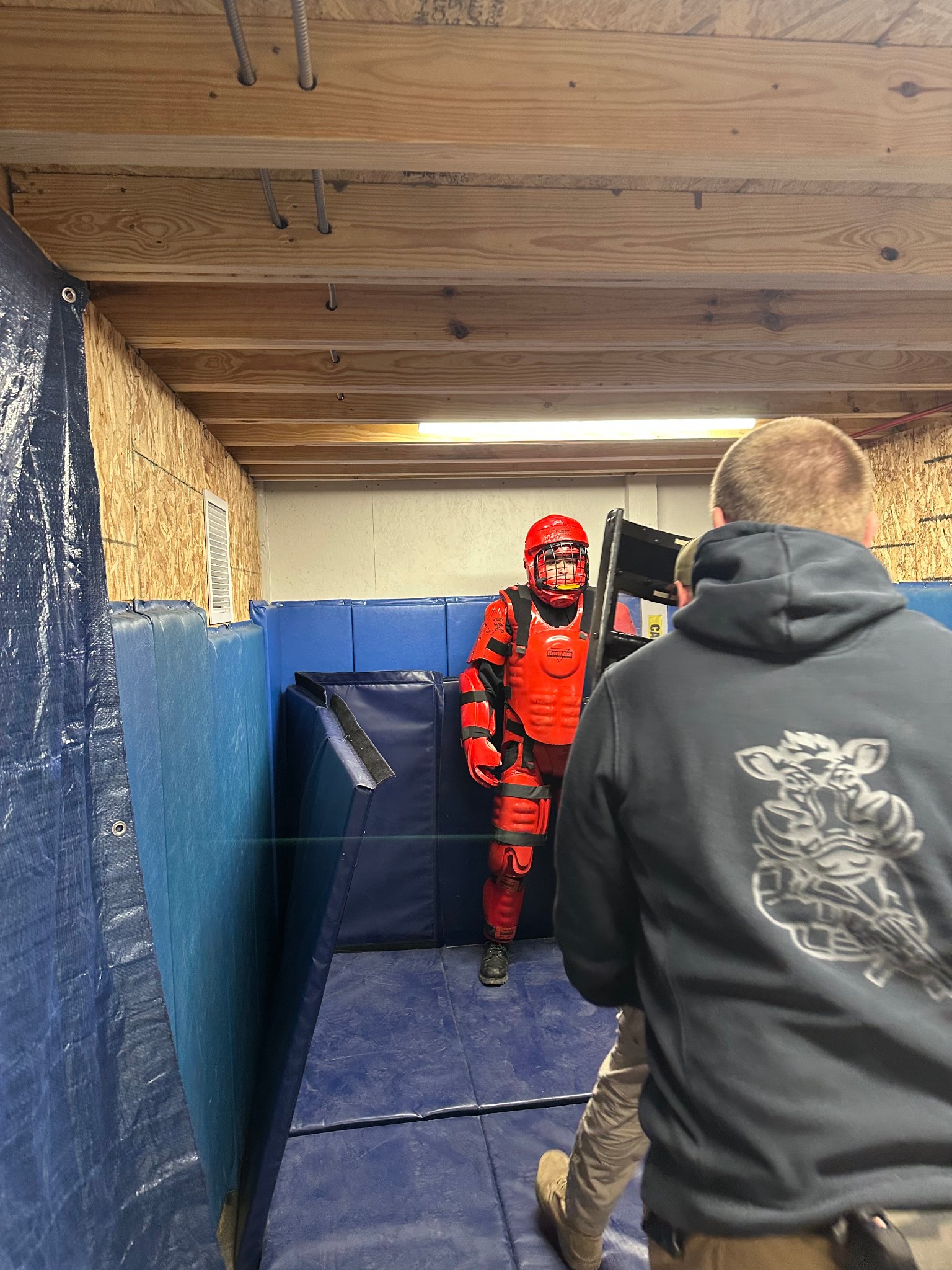 Force-on-force training with red man suit — indoor range