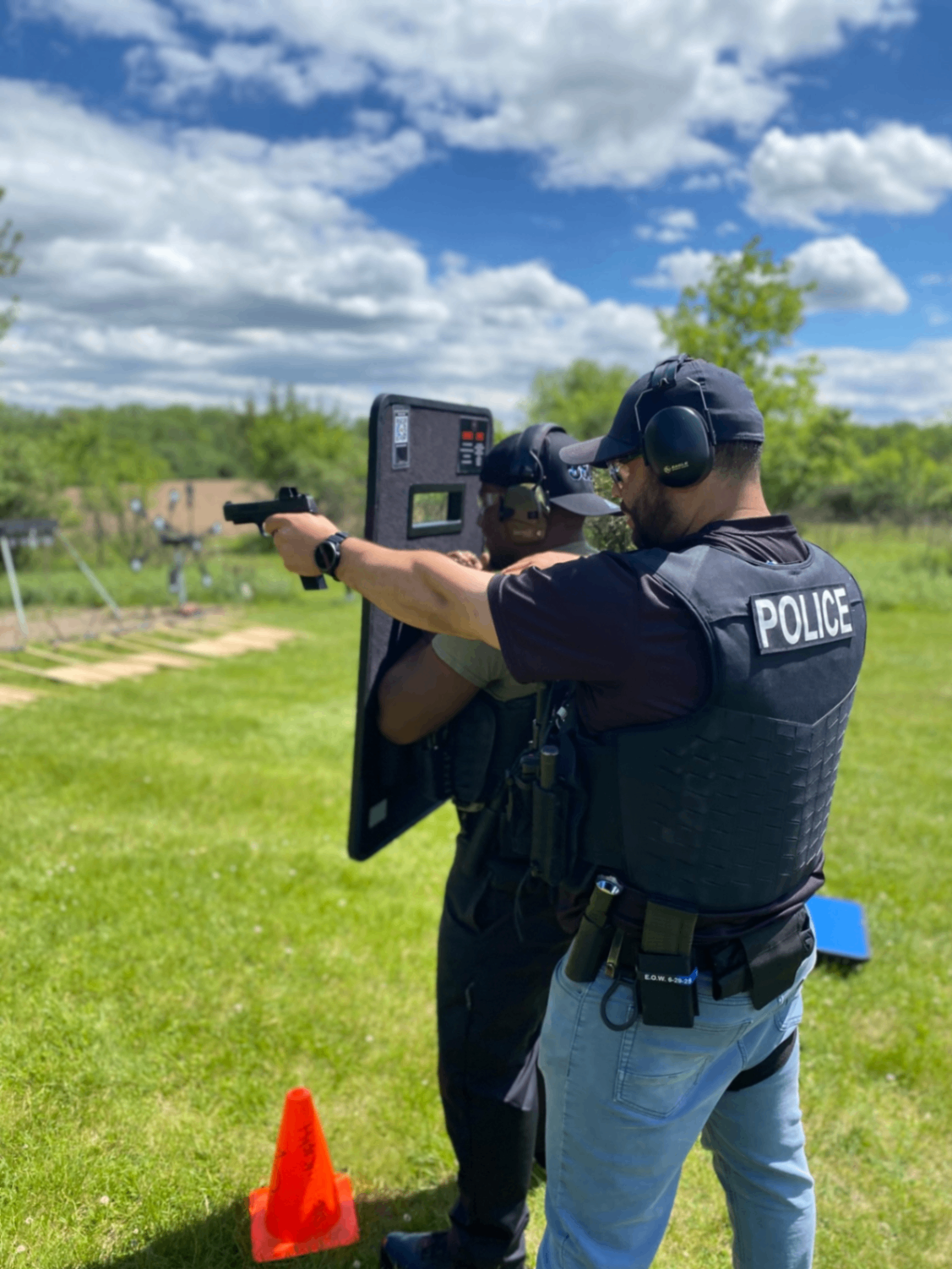 Police officer ballistic shield pistol drill — outdoor range